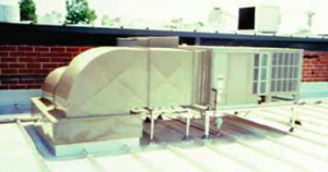 This frame-mounted HVAC unit uses pipe supports that extend to the building structure and are flashed through the roof using rubber pipe.