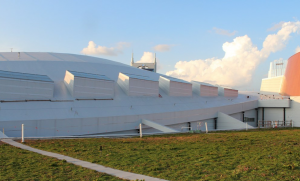 Because the green-roof portion is confined to the middle of the roof, transporting dirt from the loading point would require traversing completed roof sections, increasing the odds of damage.