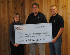 Dawn Holley, executive director of United Way of Bedford County, receives a check for $500 from Larry Price (middle), president, and Jonathan Price, vice president of Professional Roofing Contractors, Shelbyville, Tenn. The roofing contracting company donated $5 to United Way of Bedford County for each “like” added to its Facebook page while collecting entries for a charitable roof giveaway.