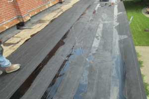 To seal two-ply asphaltic felts set in hot asphalt on a concrete roof deck, an asphaltic glaze coat was applied at the end of the day. Because of the inherent tackiness of the asphalt until it oxidizes, Hutch has been specifying a smooth-surfaced modified bitumen cap sheet, eliminating the glaze coat.