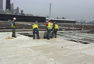 Sixty-six different types and sizes of precast concrete roof channels, weighing between 225 and 600 pounds, were hoisted by a modified crane. All 30,000 had to be inspected and approved before installation.