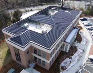 The roof consists of 60-mil TPO membrane fully adhered on low-slope areas and System 2500 mechanically seamed standing-seam panels on the steep-slope areas.