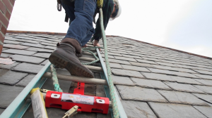 The SLATOR tool fastens to a steep slate or asphalt shingle roof and firmly clamps a ladder into position.
