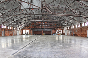 The hangar is a unique historical building; therefore, the designer wanted to keep the heritage of the building intact while transforming it into an elegant, updated and functional facility.