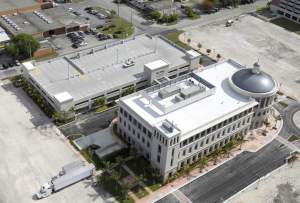 An asphaltic cap sheet with a factory-applied reflective roof coating is installed over three glass-fiber ply sheets and a venting base sheet. The reflective coating reduces heat gain, and insulating concrete provides a stable substrate and high R-value. PHOTO: Aerial Photography Inc.