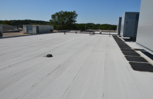 The owner preferred a granule-surfaced modified bitumen roof system for durability against repeated foot traffic.