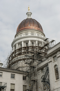 To remain proportional with the larger building, a new, higher copper-covered dome was built to replace the original cupola. 