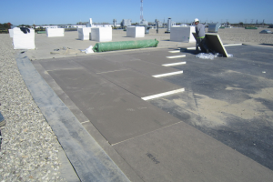 PHOTO 4: On this roof, the existing loose-laid membrane was removed, open insulation joints filled with spray-foam insulation and new insulation added to meet current code requirements. A new 90-mil EPDM membrane was installed and existing ballast moved onto it to 10-pounds-per-square-foot coverage.
