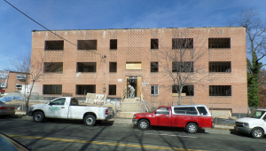 three low-rise apartment buildings at the intersection of Southern Avenue and Benning Road in Washington, D.C., stood derelict and abandoned, uninhabitable reminders of 1960s brick and block construction.