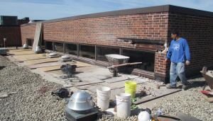 PHOTO 3A: The new roofing at SD 73 Elementary North was encroaching on this clerestory sill and required that it be raised. As part of this project, the steel lintel was exposed. It was prepped, primed and painted and new through-wall flashing was installed.