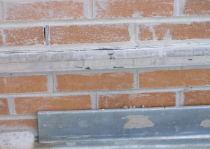 PHOTO 3: Still under construction, the stainless-steel counterflashing has been installed. The roof base flashing will terminate below the stainless-steel counterflashing receiver. Hutch prefers brick below the through-wall flashing and above the roof deck, though the masonry mortar joints below the through-wall flashing should have been struck flush.